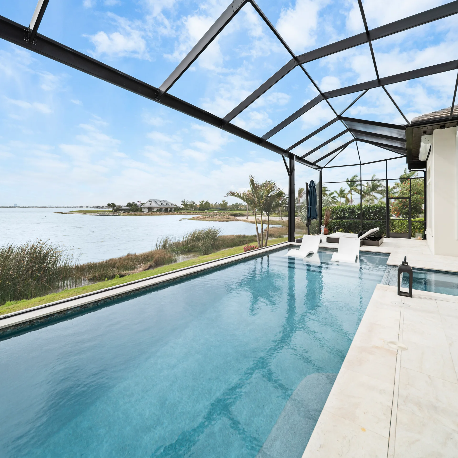 Screened pool cage over a custom pool and paver deck in Sarasota, Florida