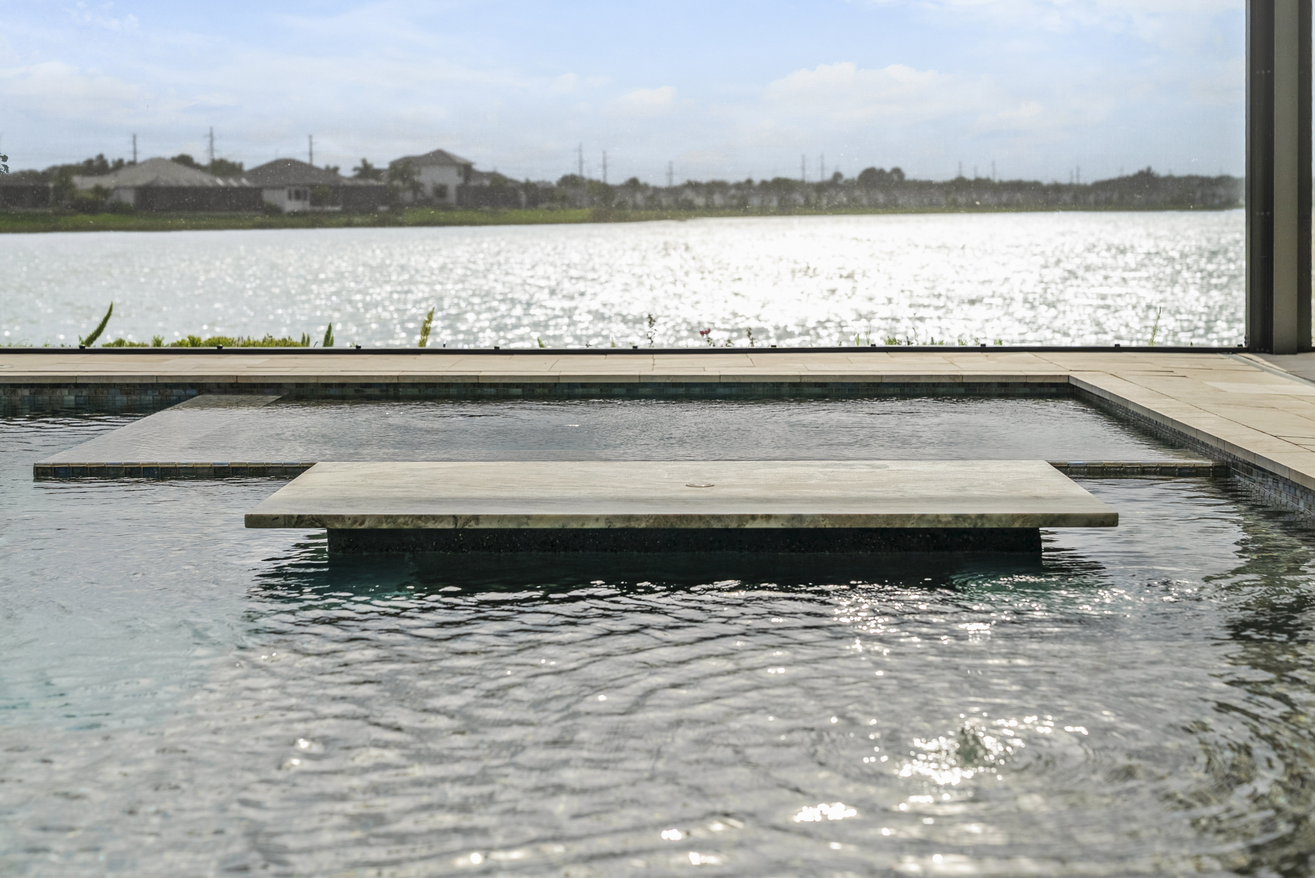 Custom pool design and construction in Nokomis, FL - Swim Inc. new build with architectural hardscape and Florida landscaping