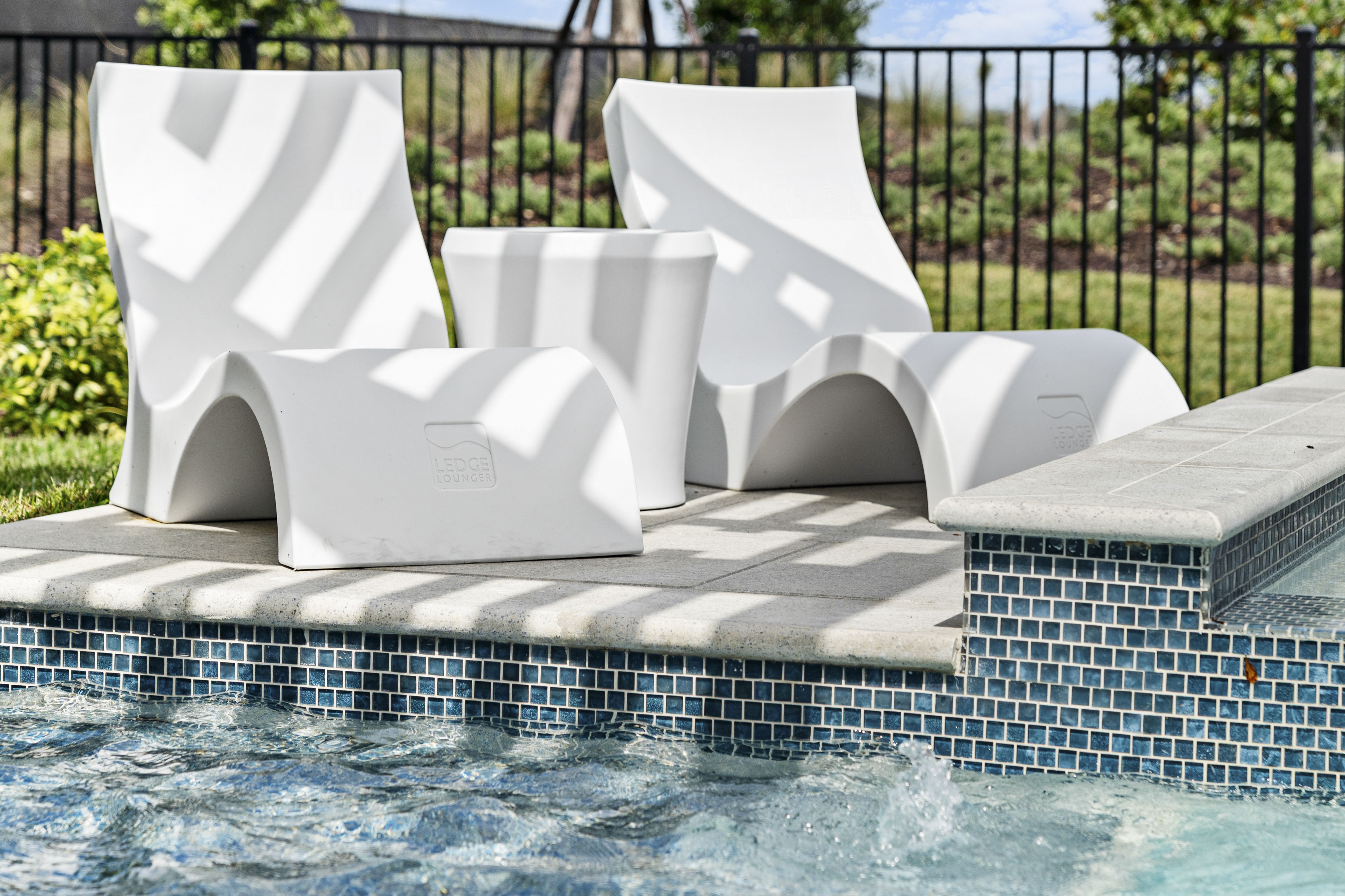 Raised sun shelf with shallow water and bubbler on geometric pool, Venice FL